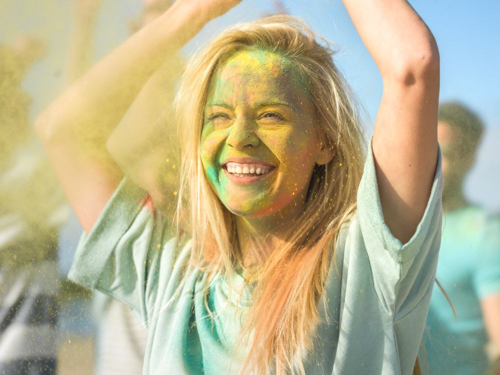 Woman Dances in Celebration of Holi Festival With Her Friends.