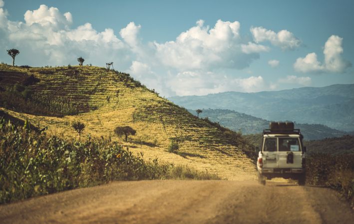 Car driving on road in tropical rural mountains