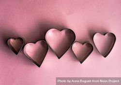 Heart shaped cookie cutters on pink background 56GGkP