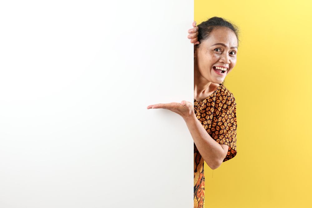 Indonesian Mother Pointing on Empty Space on the Left