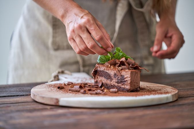 Anonymous chef decorating chocolate cake pastry
