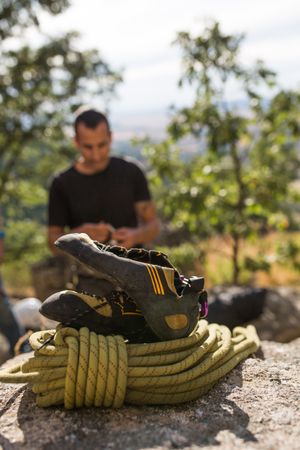 A climber is preparing his ropes to start climbing