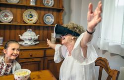 Older woman using virtual reality glasses