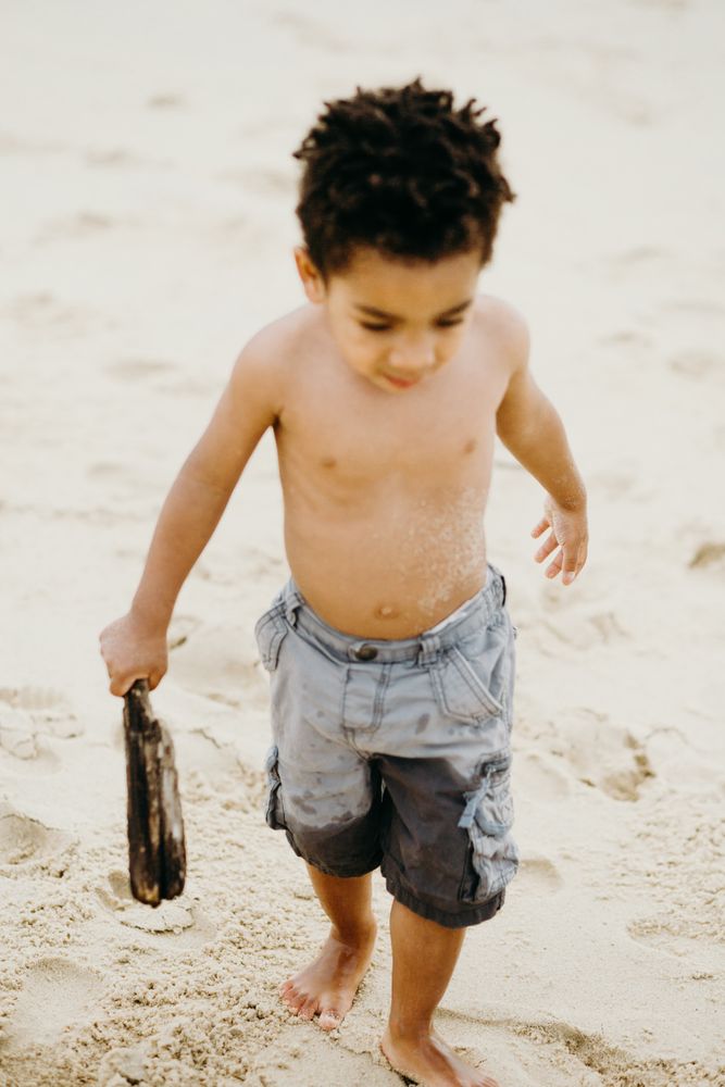 Black boy playing on beach