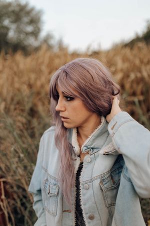 Smoking trendy woman in autumn nature