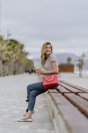 Young woman sitting on bench