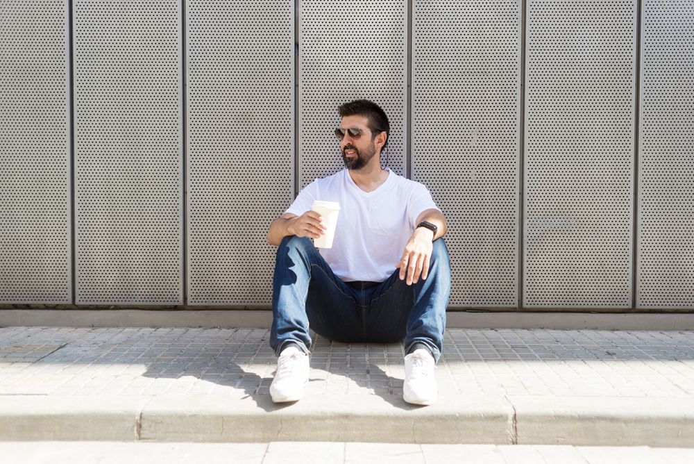 Latino man relaxing sitting outside