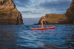 Woman on paddleboard floating in sea