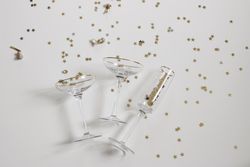 Flutes of champagne with golden confetti