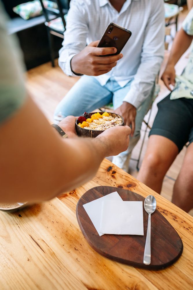 Chef showing healthy bowl to food bloggers and influencers taking photos in cooking master class