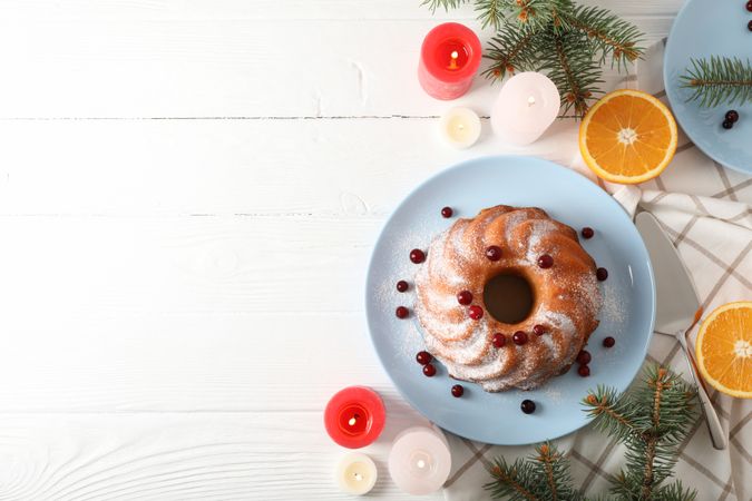 Cake with powder sugar and cranberry on table. Christmas concept