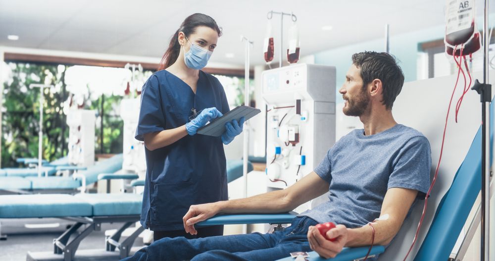 Man Donating Blood For People In Need In Hospital.