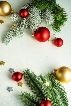 Top view of counter with fir branch and gold and red baubles