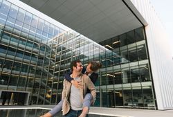 Cheerful couple having fun and hugging on street in downtown