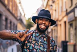 Stylish Black man having fun on the city street