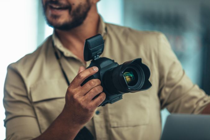 Portrait of a photographer holding a DSLR camera
