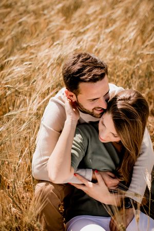 Serene lovers embracing on wheat field