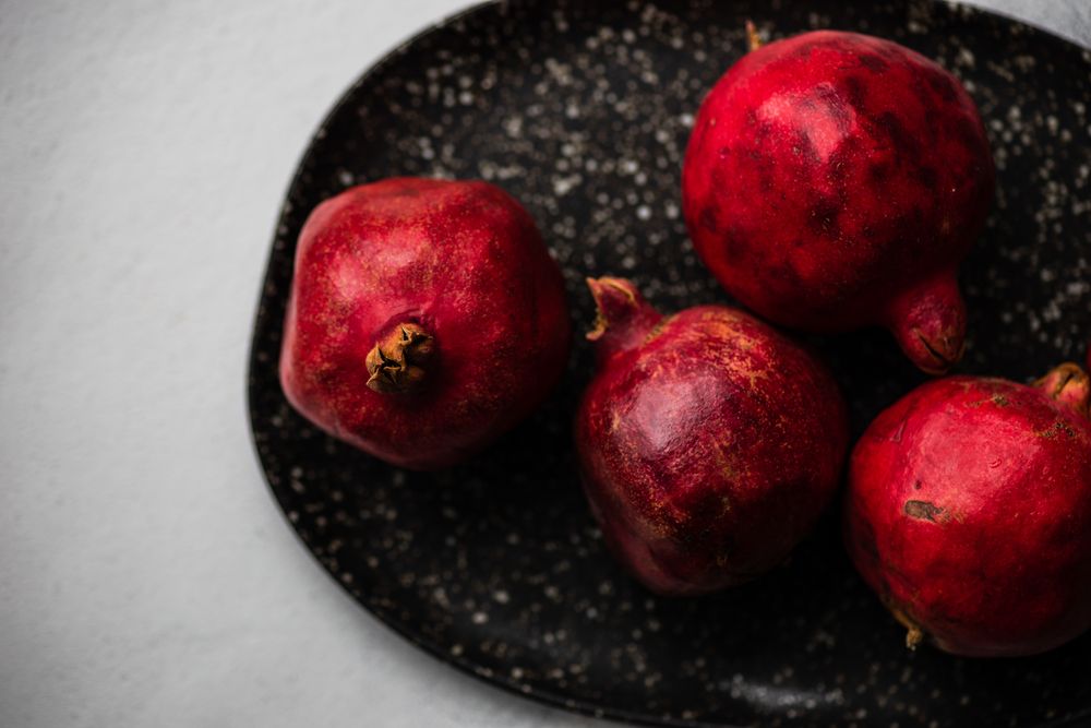 Top view of plate of whole pomegranate