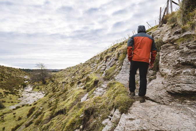 Man walking on hill near valley