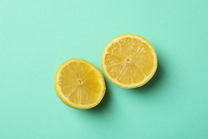 Lemon halves on mint background. Ripe fruit