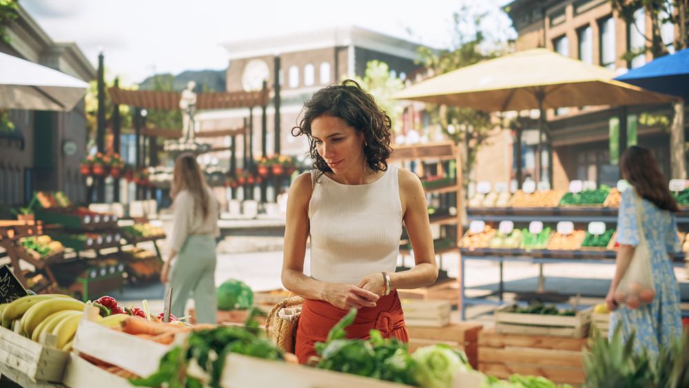 Brazilian Female Customer Buying Sustainable Organic Tomatoes From a Local Farmers Stall.