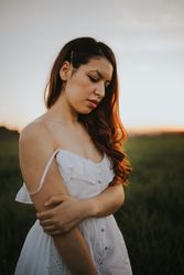 Barefoot woman with flowers in meadow