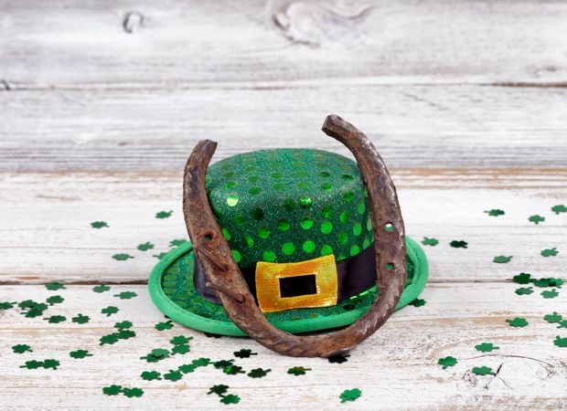 Rusty horseshoe with hat and clovers for St Patrick