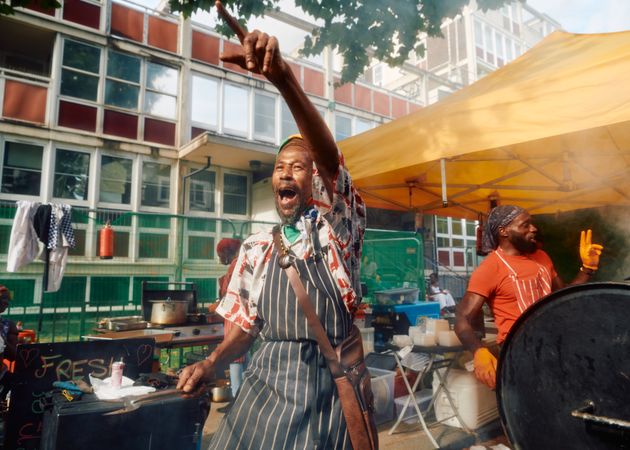 London, England, United Kingdom - August 27, 2022: Happy man cooking street food in Notting Hill