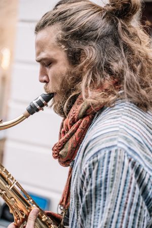 Male saxophonist plays Sax in the street