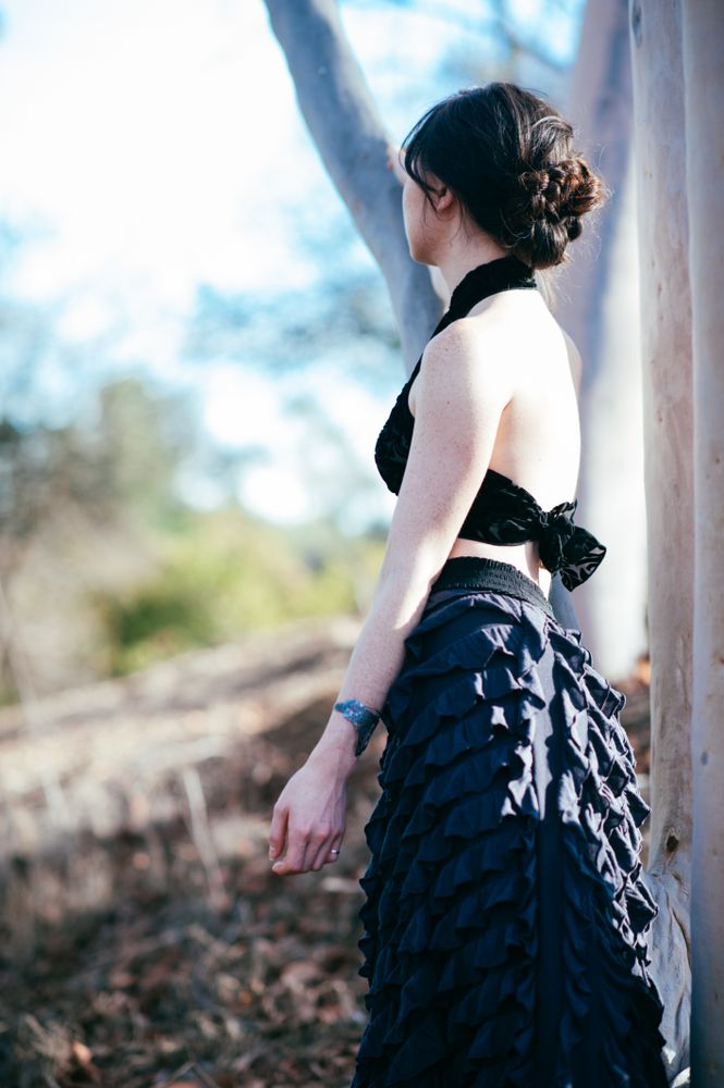 Back view portrait of woman contemplating in the woods