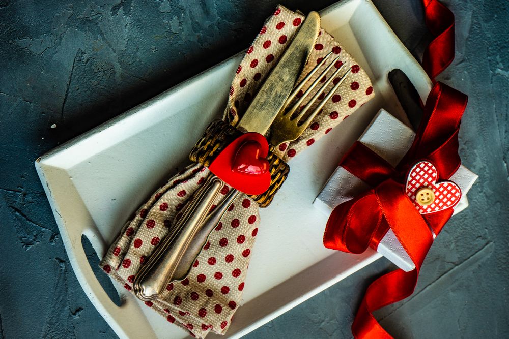 St. Valentine day table setting with dotted napkin on plate