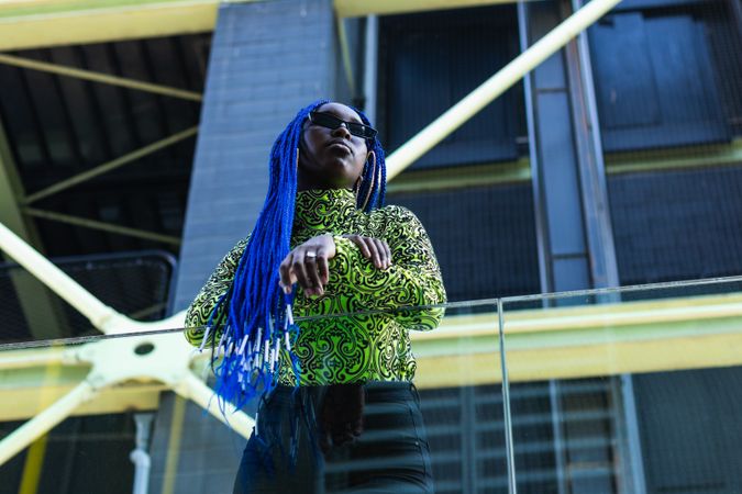 Determined Black woman in stylish wear in city