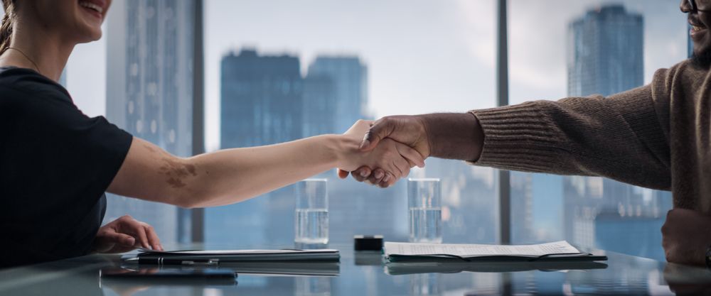 Close Up Of Female and Male Business Partners Sign Successful Deal