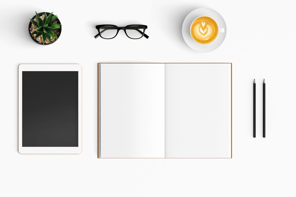 Modern workspace with coffee cup, smartphone, paper, notebook
