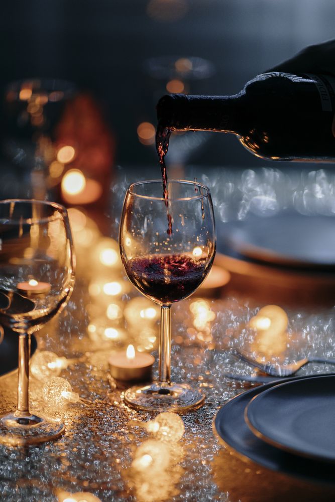 Close up of hand pouring wine for holiday dinner