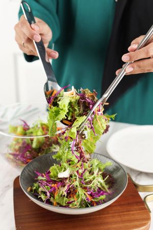 Female Hand Preparing Healthy Vegetable Salad for Breakfast
