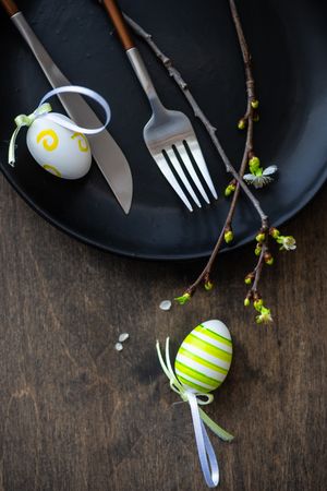 Easter table setting with decorated eggs and budding branch