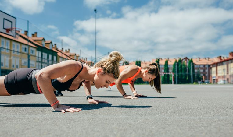 Sportswomen doing push-ups