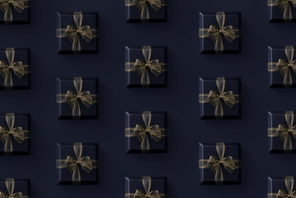 Gift boxes with gold ribbon on dark background