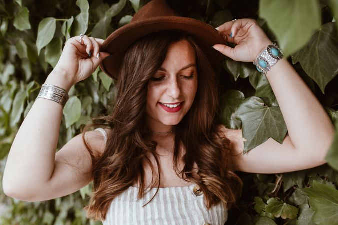 Fashionable woman in front of bush