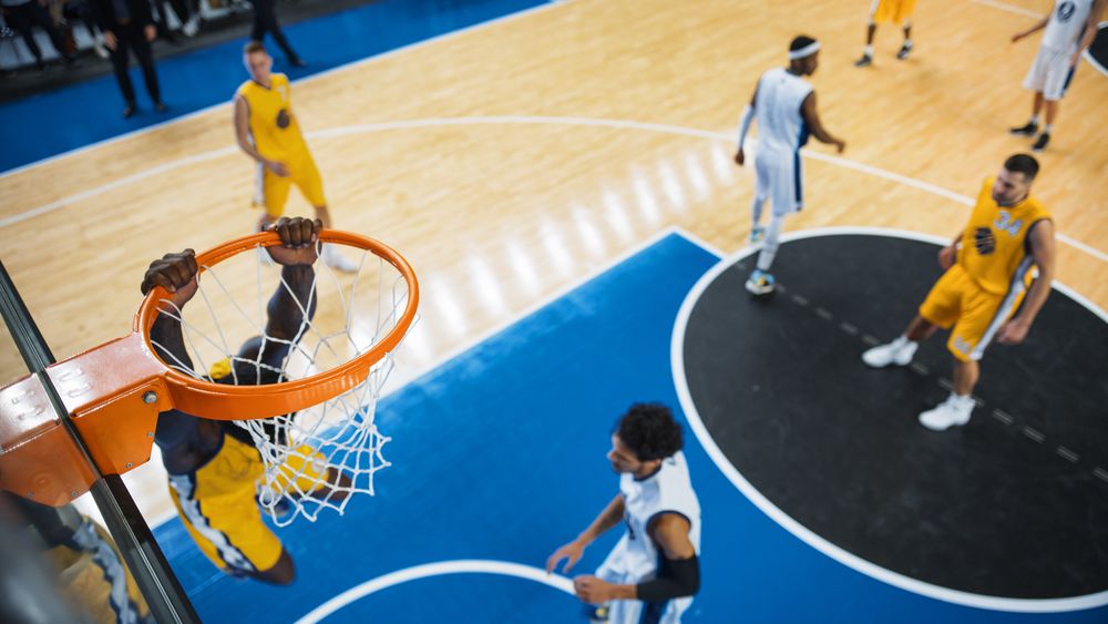 Cinematic College Basketball Tournament: Two Young Successful Diverse Teams Play a Championship Match in a Modern Arena.