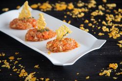 Tasty Quenelles of tomato fondue and Parmensan tile in ornamental plate