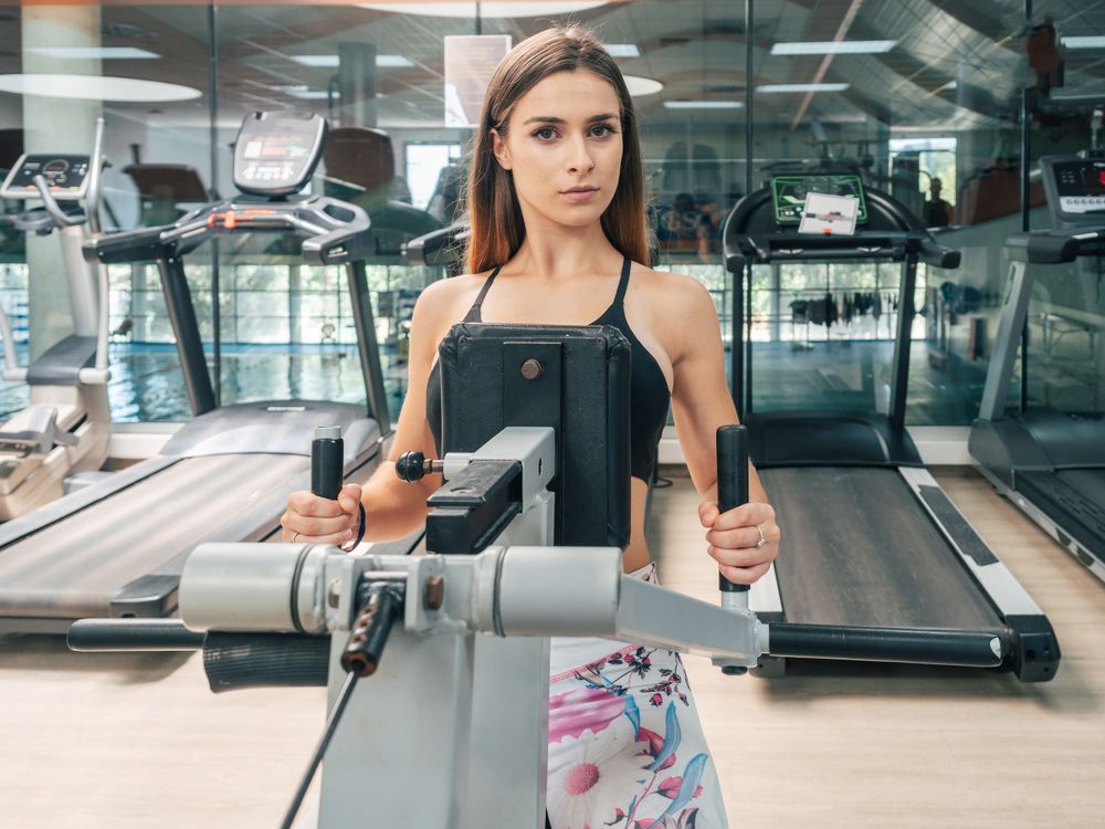 Strong female on row machine