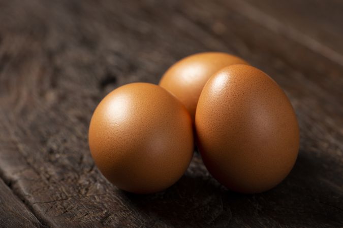 Brown chicken eggs rises on the table.