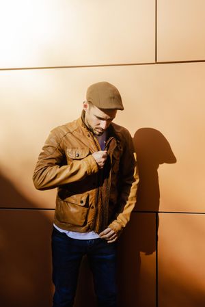 Confident guy leaning on wall