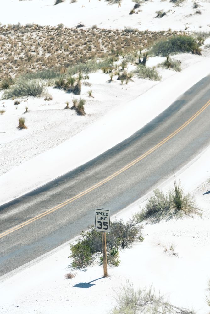 Asphalt road at scenic mountain valley and power line