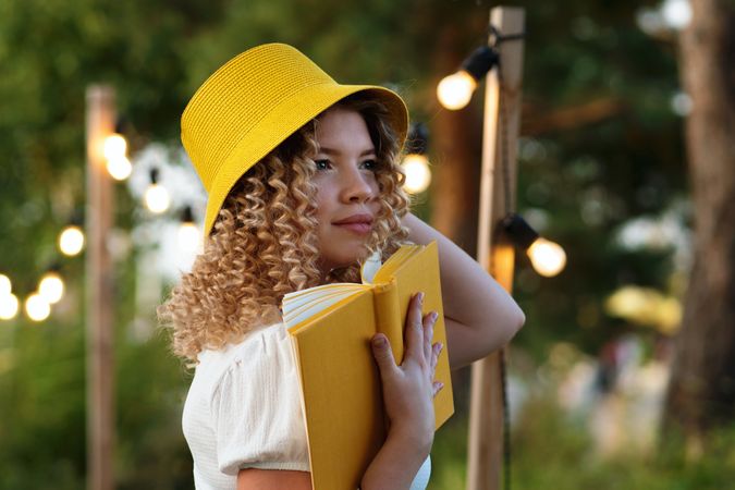 Woman with book outdoors