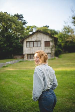 Content female walking on grass in countryside
