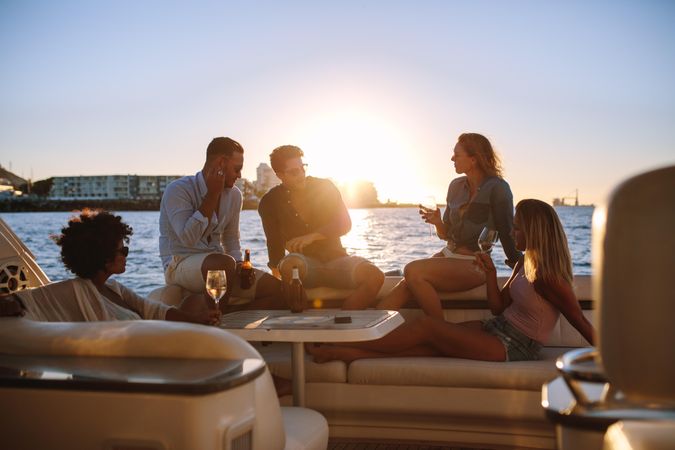 Group of travelers enjoying sunset party of yacht