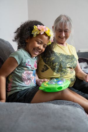 Older woman and grandchild playing at home
